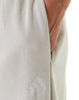 Adidas Pantaloni da donna Essentials Small Logo JC5922 Beige - tasca e logo ricamato 