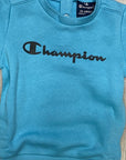 Champion tuta infant con felpa con bottoncini al collo e pantalone con polsino 306186 BS157 DLPB/NBK celeste-nero